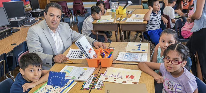 Photo of Superintendent of Schools Dr. Edwin M. Quezada working with young students Photo of Superintendent of Schools Dr. Edwin M. Quezada working with young students